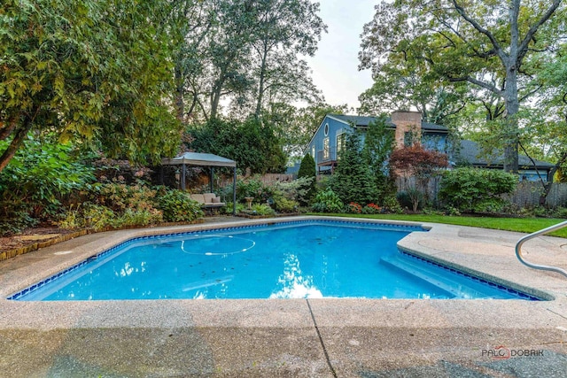 pool with fence, a gazebo, and a patio area