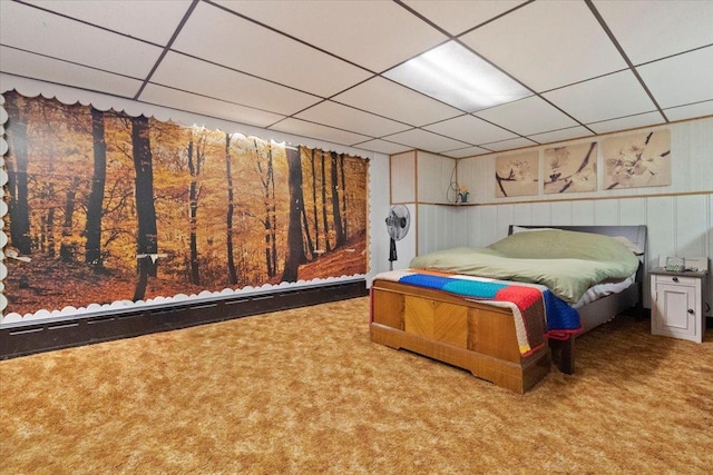 bedroom featuring carpet floors and a drop ceiling