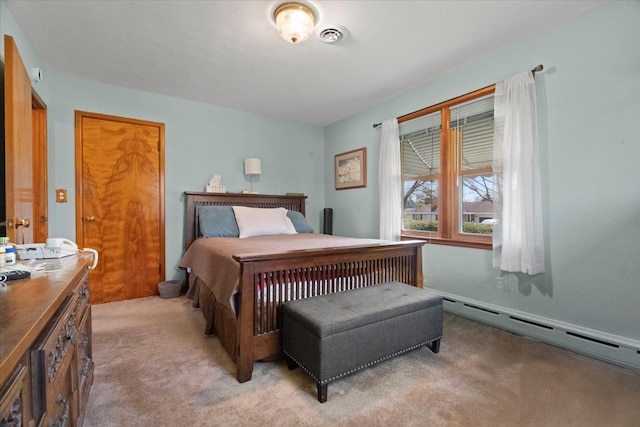 bedroom with visible vents, a baseboard heating unit, and light carpet