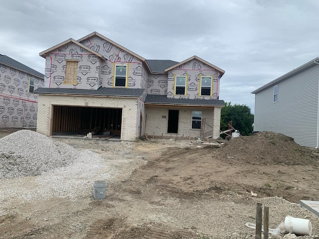 814 English St, Braidwood, IL 60408 - property in mid-construction featuring a garage, brick siding, dirt driveway, and roof with shingles