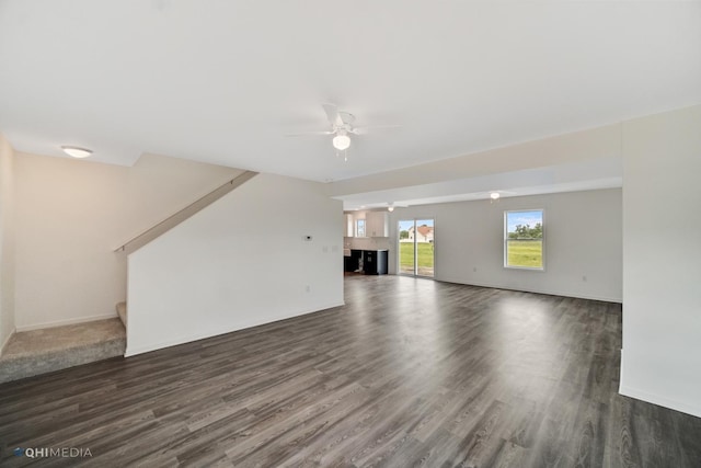 814 English St, Braidwood, IL 60408 - unfurnished living room featuring dark wood-style flooring, a ceiling fan, stairway, and baseboards