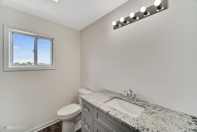 814 English St, Braidwood, IL 60408 - bathroom featuring toilet, wood finished floors, vanity, and baseboards