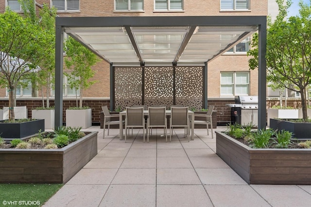 view of patio with outdoor dining area, a vegetable garden, and area for grilling