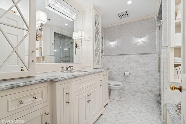 bathroom featuring ornamental molding, toilet, tiled shower, wallpapered walls, and vanity