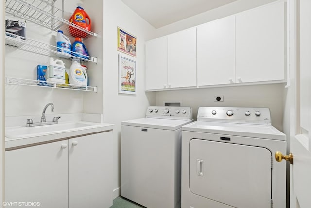 laundry room featuring washing machine and dryer and cabinet space