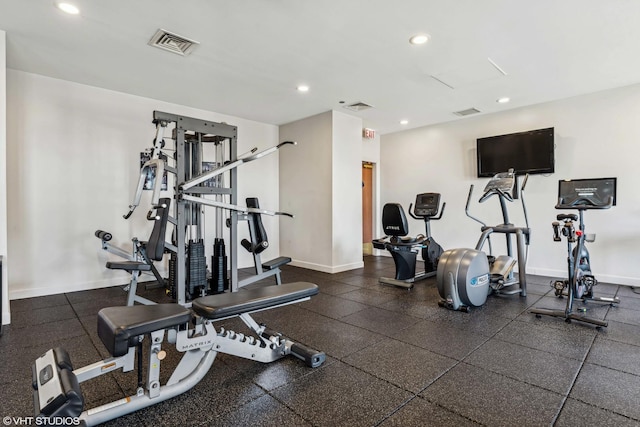 exercise room with recessed lighting and baseboards