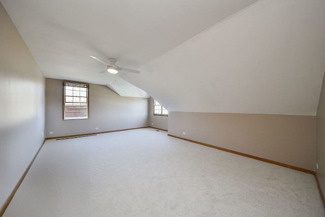 additional living space with lofted ceiling, carpet, ceiling fan, and baseboards