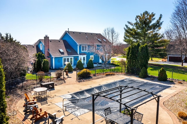 exterior space featuring fence, a fenced in pool, and a patio area