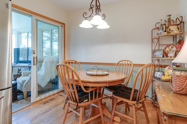 dining room with visible vents and hardwood / wood-style floors