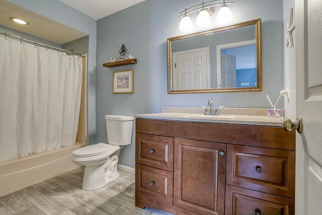 bathroom featuring toilet, baseboards, shower / tub combo, and vanity