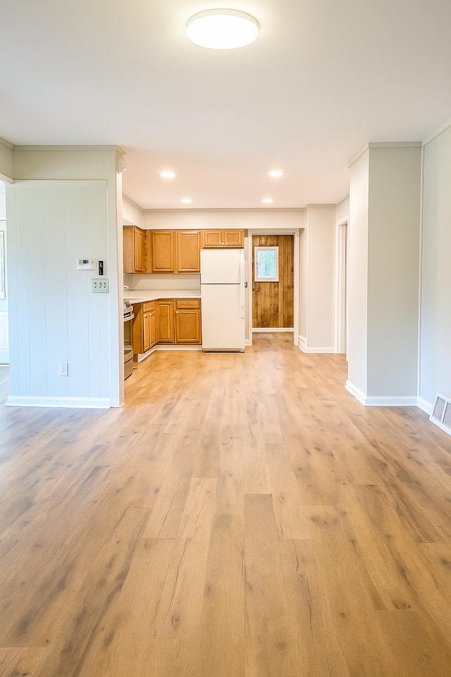 618 Princeton Rd, Depue, IL 61322 - kitchen featuring freestanding refrigerator, brown cabinets, light wood-style floors, light countertops, and stainless steel range