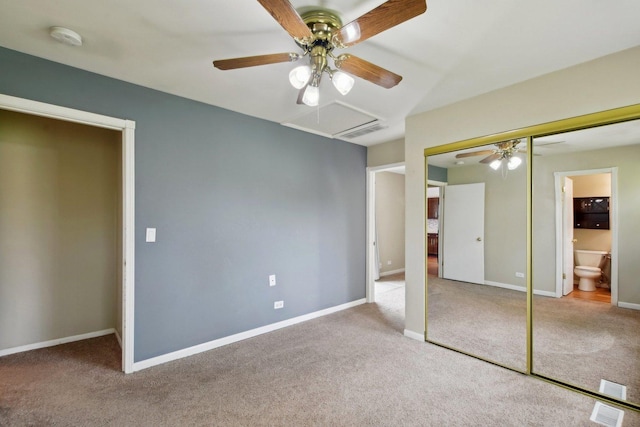 unfurnished bedroom featuring carpet floors, attic access, visible vents, and a closet