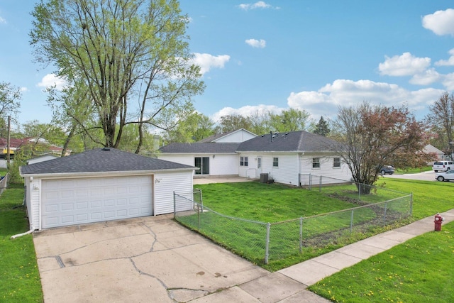 ranch-style house with a garage, fence private yard, and a front lawn