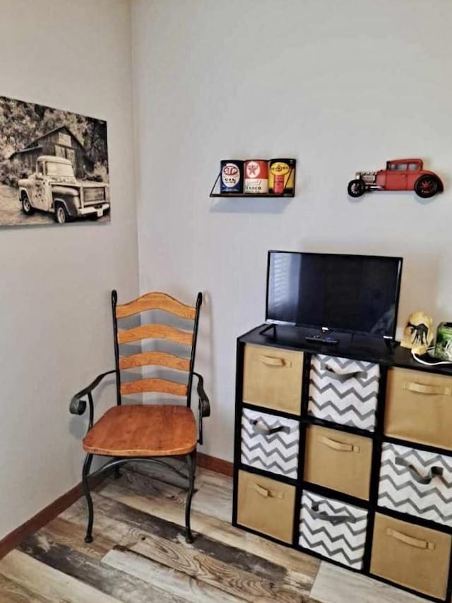 sitting room with wood finished floors and baseboards