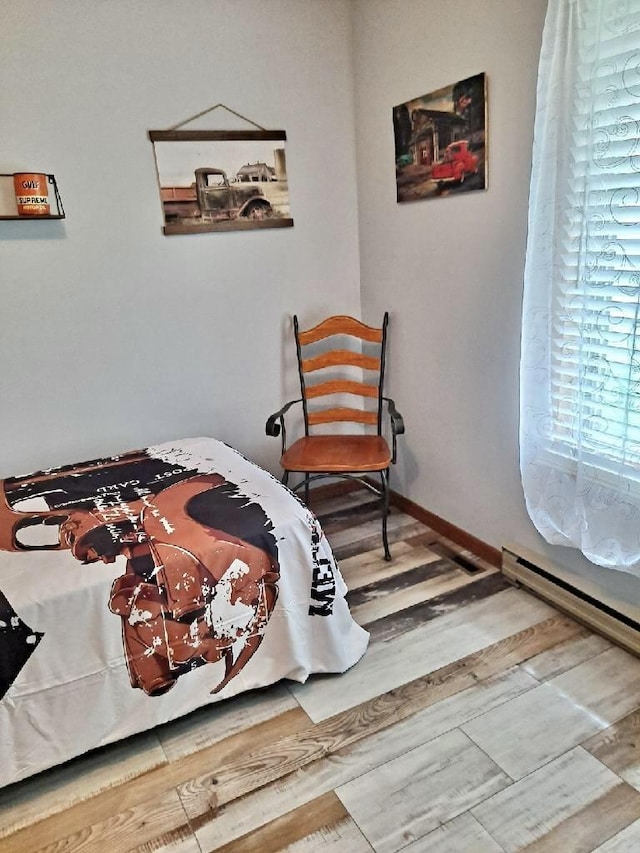 bedroom featuring wood finished floors and baseboards
