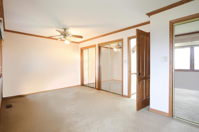 8360 W 100th Pl, Palos Hills, IL 60465 - unfurnished bedroom featuring a ceiling fan, visible vents, crown molding, light colored carpet, and multiple closets