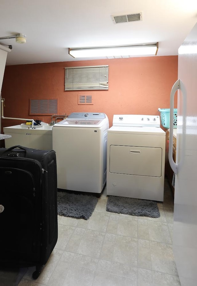 8360 W 100th Pl, Palos Hills, IL 60465 - clothes washing area with washing machine and dryer and visible vents