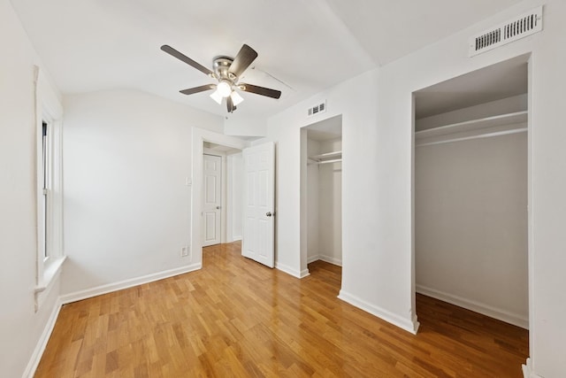 unfurnished bedroom featuring visible vents, light wood-style floors, and baseboards
