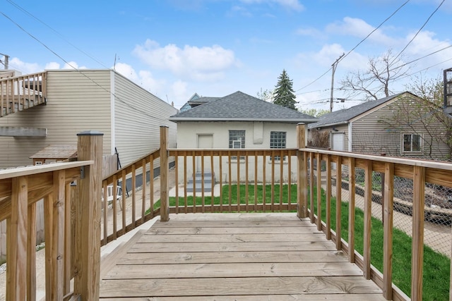 wooden deck with fence and an outdoor structure