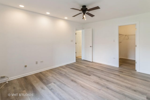 246 George St Unit C, Bensenville, IL 60106 - unfurnished bedroom with recessed lighting, baseboards, a walk in closet, and wood finished floors