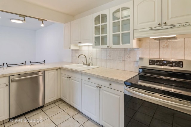 246 George St Unit C, Bensenville, IL 60106 - kitchen with a sink, light countertops, under cabinet range hood, stainless steel appliances, and light tile patterned flooring