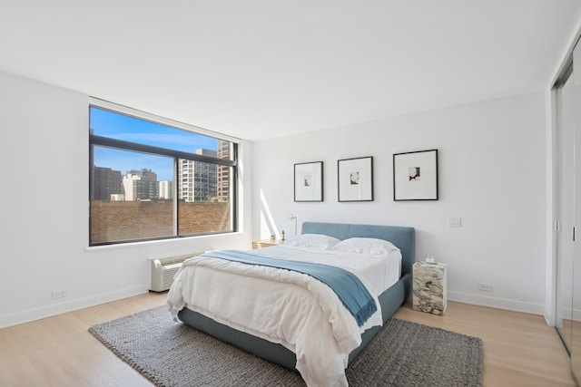 bedroom with baseboards and wood finished floors