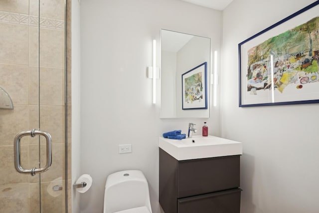 full bath featuring toilet, a shower stall, and vanity
