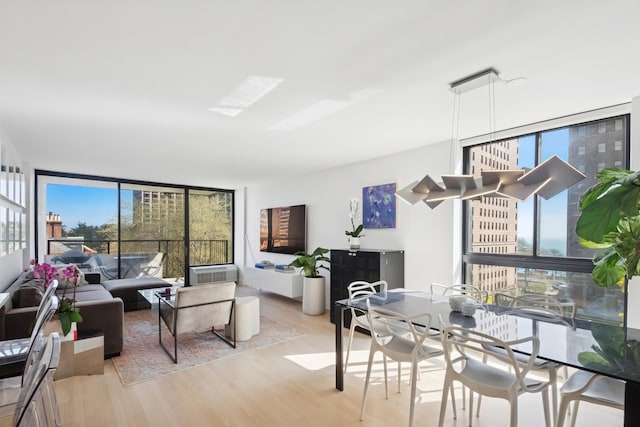 dining room featuring expansive windows and wood finished floors