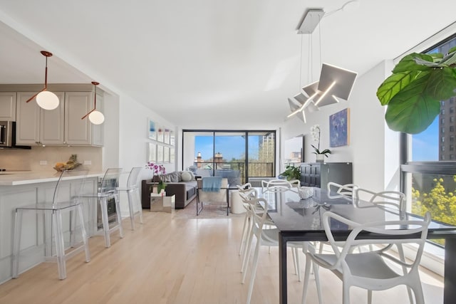 dining area featuring light wood-type flooring