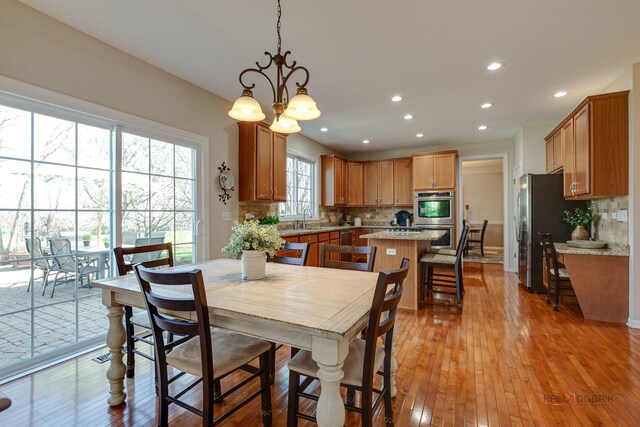 dining area with recessed lighting and light wood-style flooring
