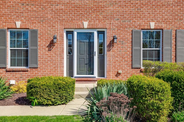 property entrance with brick siding
