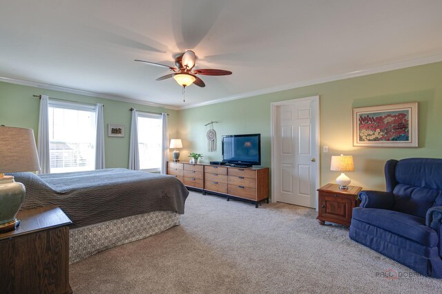 bedroom featuring ornamental molding, ceiling fan, and light colored carpet