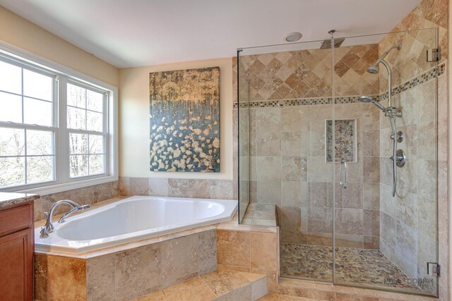 bathroom featuring a garden tub and a shower stall