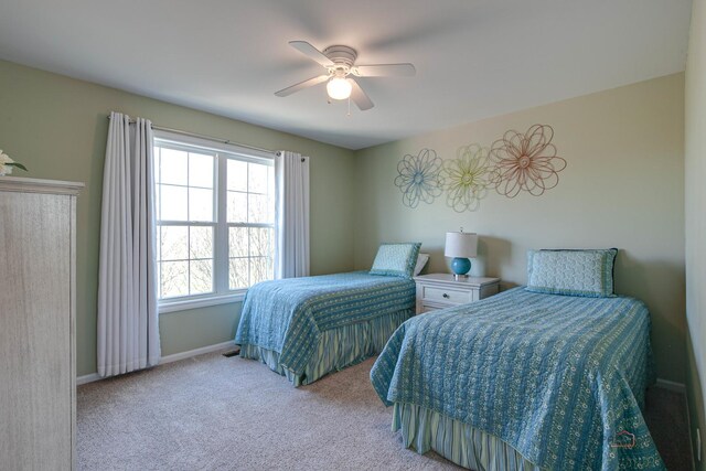carpeted bedroom with baseboards and a ceiling fan