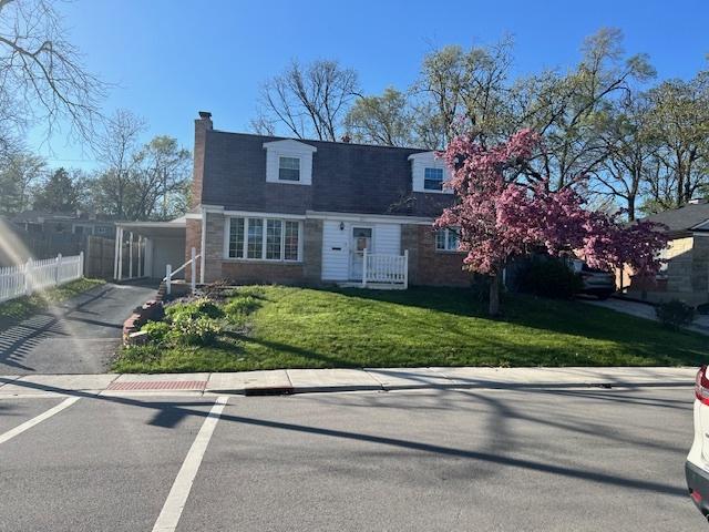 330 Oakwood St, Park Forest, IL 60466 - cape cod home with a front yard, an attached carport, aphalt driveway, a chimney, and fence