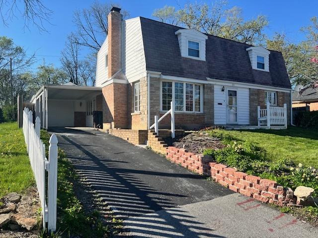 330 Oakwood St, Park Forest, IL 60466 - view of front facade with a chimney, fence, driveway, and a front yard