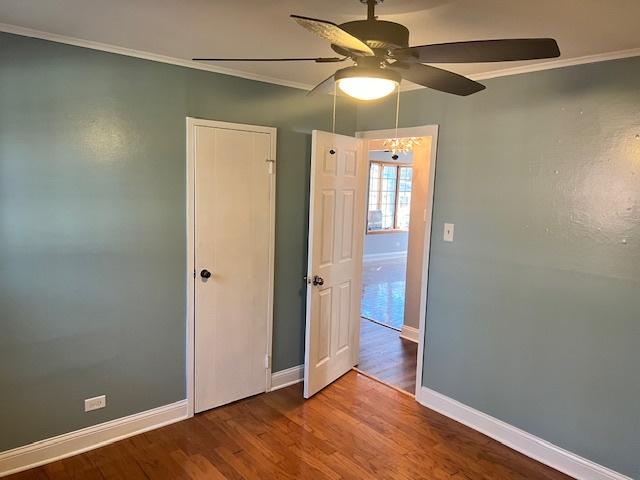 330 Oakwood St, Park Forest, IL 60466 - unfurnished bedroom with crown molding, wood finished floors, and baseboards