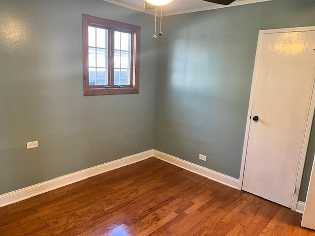 330 Oakwood St, Park Forest, IL 60466 - unfurnished room with ornamental molding, a ceiling fan, dark wood-style flooring, and baseboards