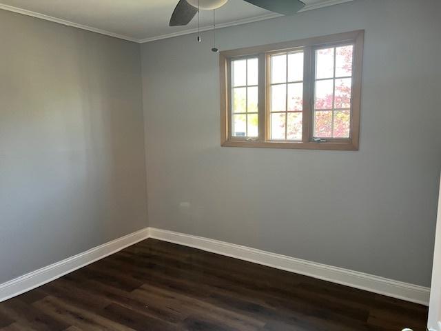 330 Oakwood St, Park Forest, IL 60466 - unfurnished room with baseboards, a ceiling fan, crown molding, and dark wood-style floors