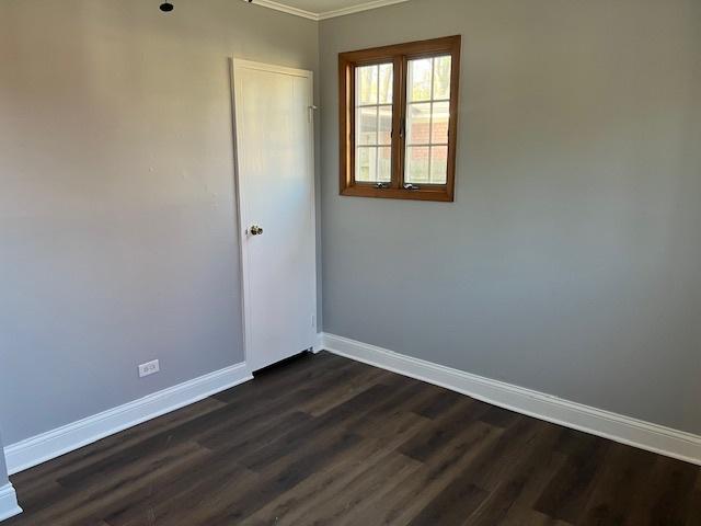 330 Oakwood St, Park Forest, IL 60466 - empty room with ornamental molding, dark wood-style floors, and baseboards