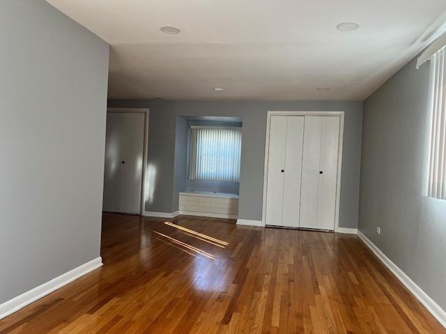 330 Oakwood St, Park Forest, IL 60466 - unfurnished bedroom with wood finished floors and baseboards
