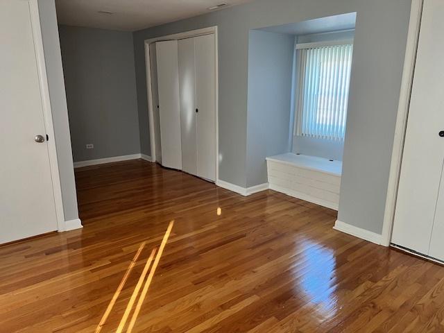 330 Oakwood St, Park Forest, IL 60466 - unfurnished bedroom featuring baseboards and wood finished floors