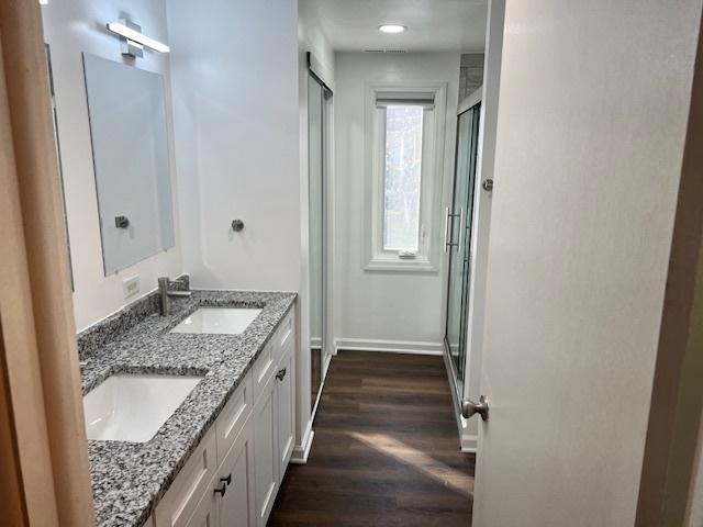 330 Oakwood St, Park Forest, IL 60466 - bathroom with wood finished floors, baseboards, a stall shower, and a sink