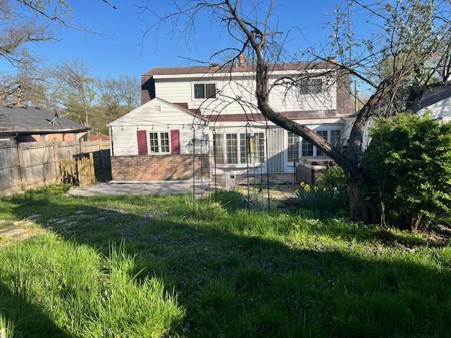 330 Oakwood St, Park Forest, IL 60466 - back of property featuring fence, a chimney, and brick siding