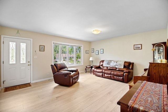 living area featuring light wood-type flooring and baseboards