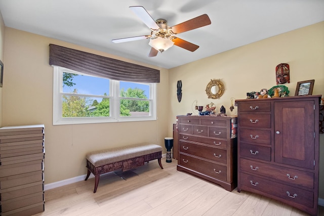 bedroom with light wood-style floors, baseboards, and a ceiling fan