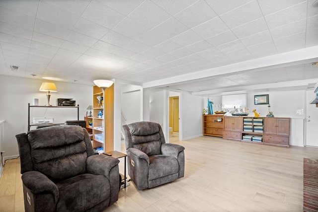 living area featuring light wood-type flooring and baseboards