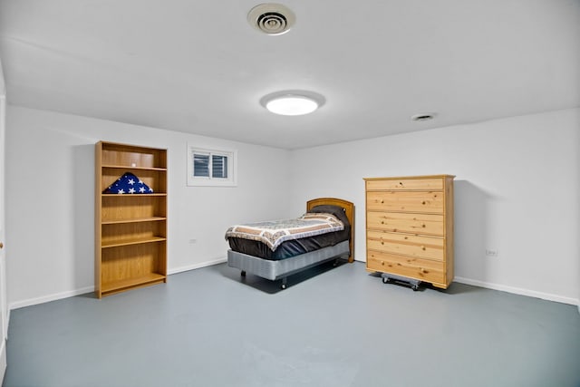 bedroom with finished concrete flooring and baseboards