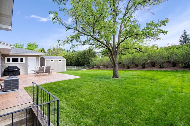 view of yard with a patio area, cooling unit, an outdoor structure, and a storage unit