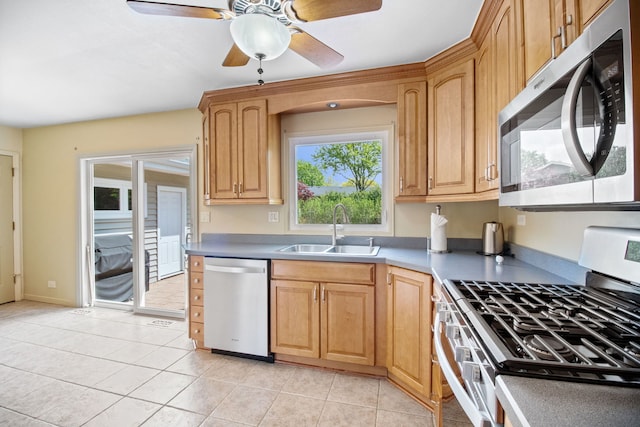kitchen featuring stainless steel appliances, a sink, ceiling fan, and light tile patterned floors